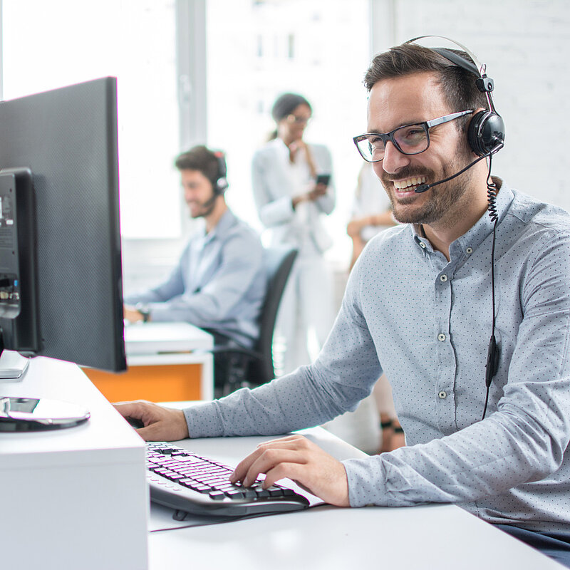 Guy in call, on pc, smiling, phone call, meeting, office,